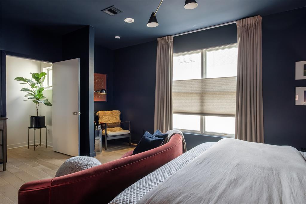 4014 Travis Street, Unit C Dallas, TX 75204 - Photo 15 of 23 a bedroom with a bed and ceiling fan