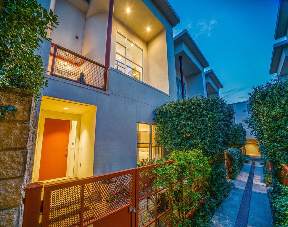 4014 Travis Street, Unit C Dallas, TX 75204 - Photo 22 of 23 a view of a house with a large windows and flower plants