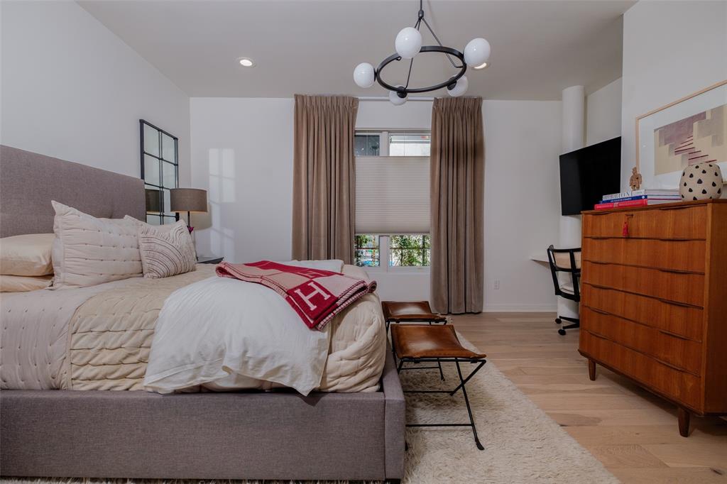 4014 Travis Street, Unit C Dallas, TX 75204 - Photo 3 of 23 a bedroom with a bed and wooden floor