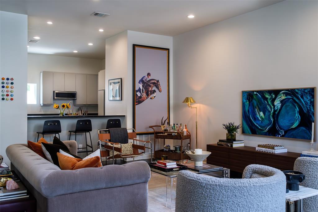 4014 Travis Street, Unit C Dallas, TX 75204 - Photo 7 of 23 a living room with furniture and wall paintings