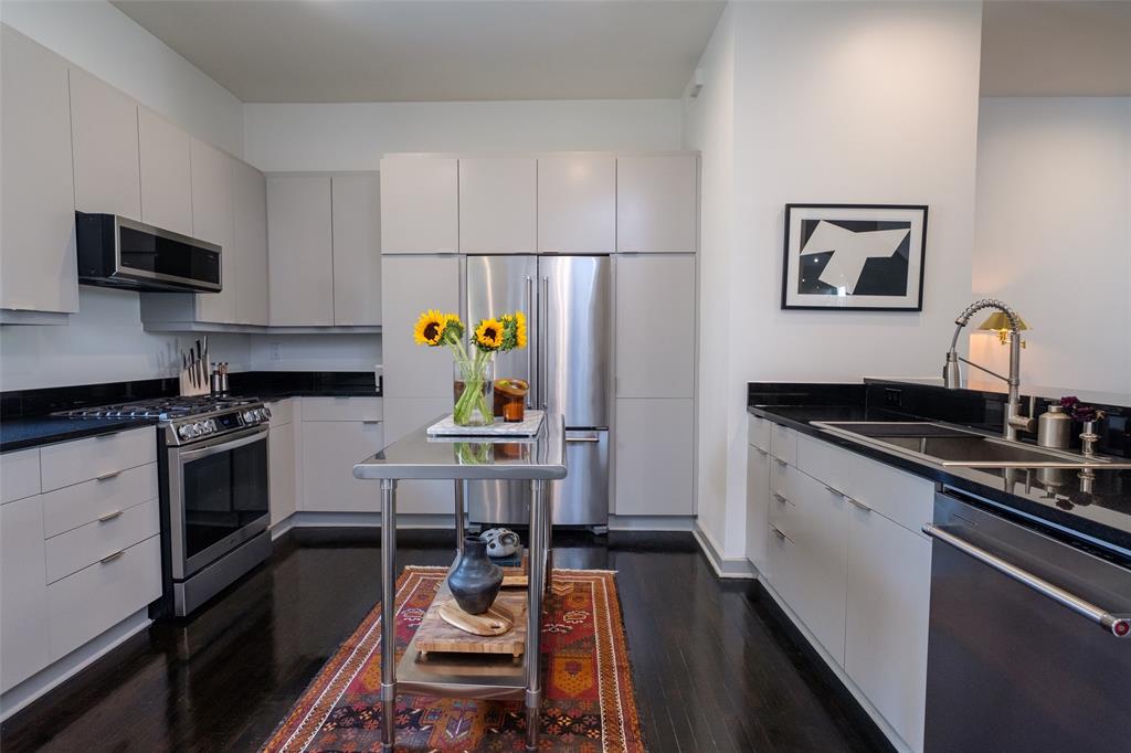 4014 Travis Street, Unit C Dallas, TX 75204 - Photo 9 of 23 a kitchen with a sink appliances and cabinets