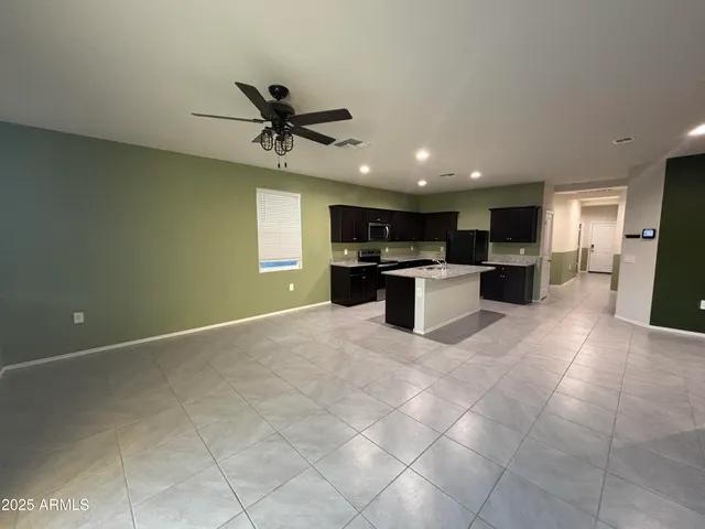 a view of a kitchen with a sink and a refrigerator