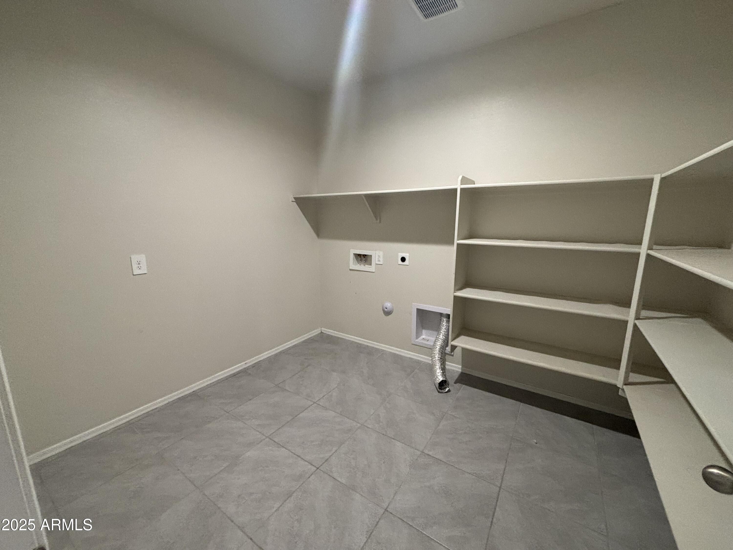 9345 Greenhouse Road Florence, AZ 85132 - Photo 5 of 13 a view of room with racks on the wall