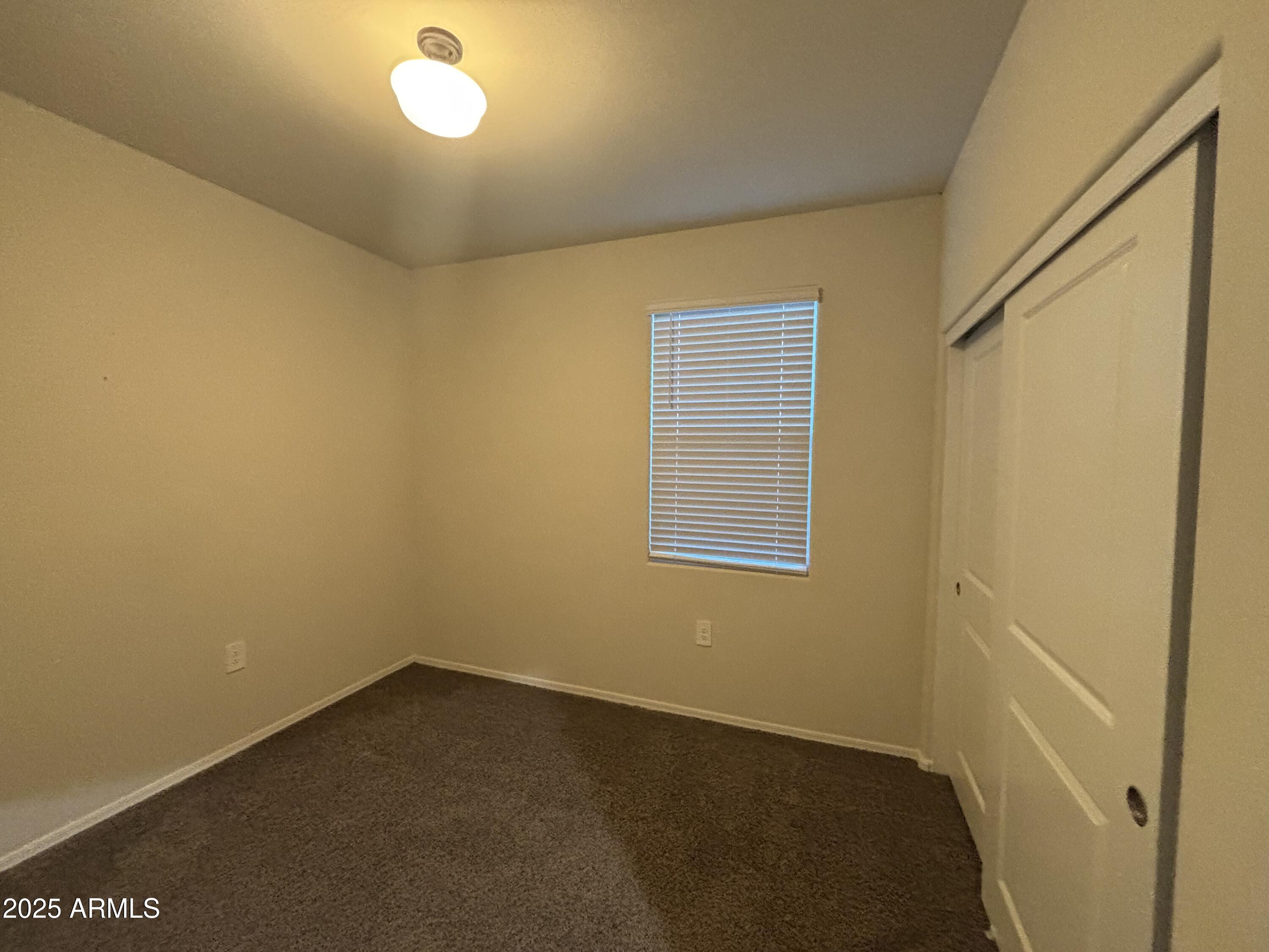9345 Greenhouse Road Florence, AZ 85132 - Photo 9 of 13 an empty room with a window