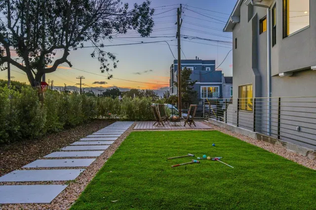 a kitchen with stainless steel appliances granite countertop a kitchen island a stove a table and chairs