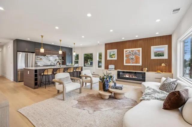 a kitchen with stainless steel appliances kitchen island granite countertop a refrigerator and a sink