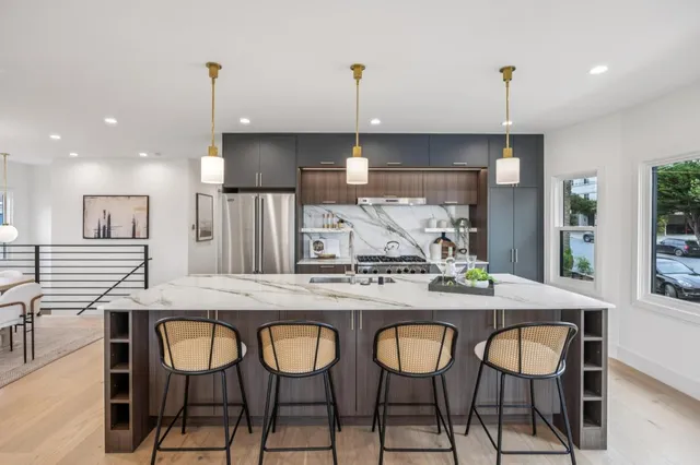 a living room with furniture and kitchen view