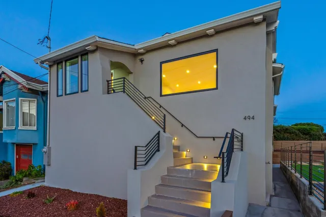 a view of a house with wooden fence