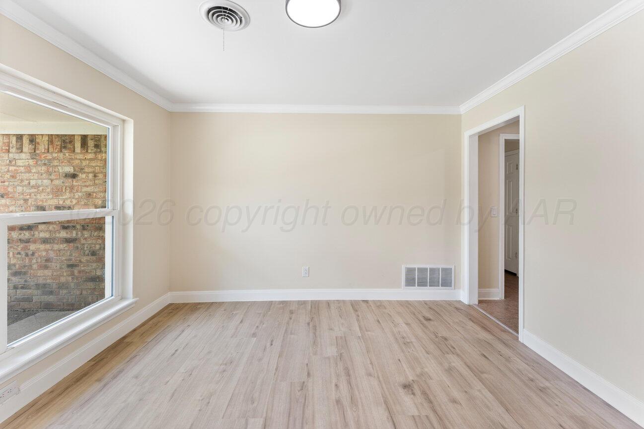 7204 Southwest 39th Avenue Amarillo, TX 79109 - Photo 6 of 51 an empty room with wooden floor and windows