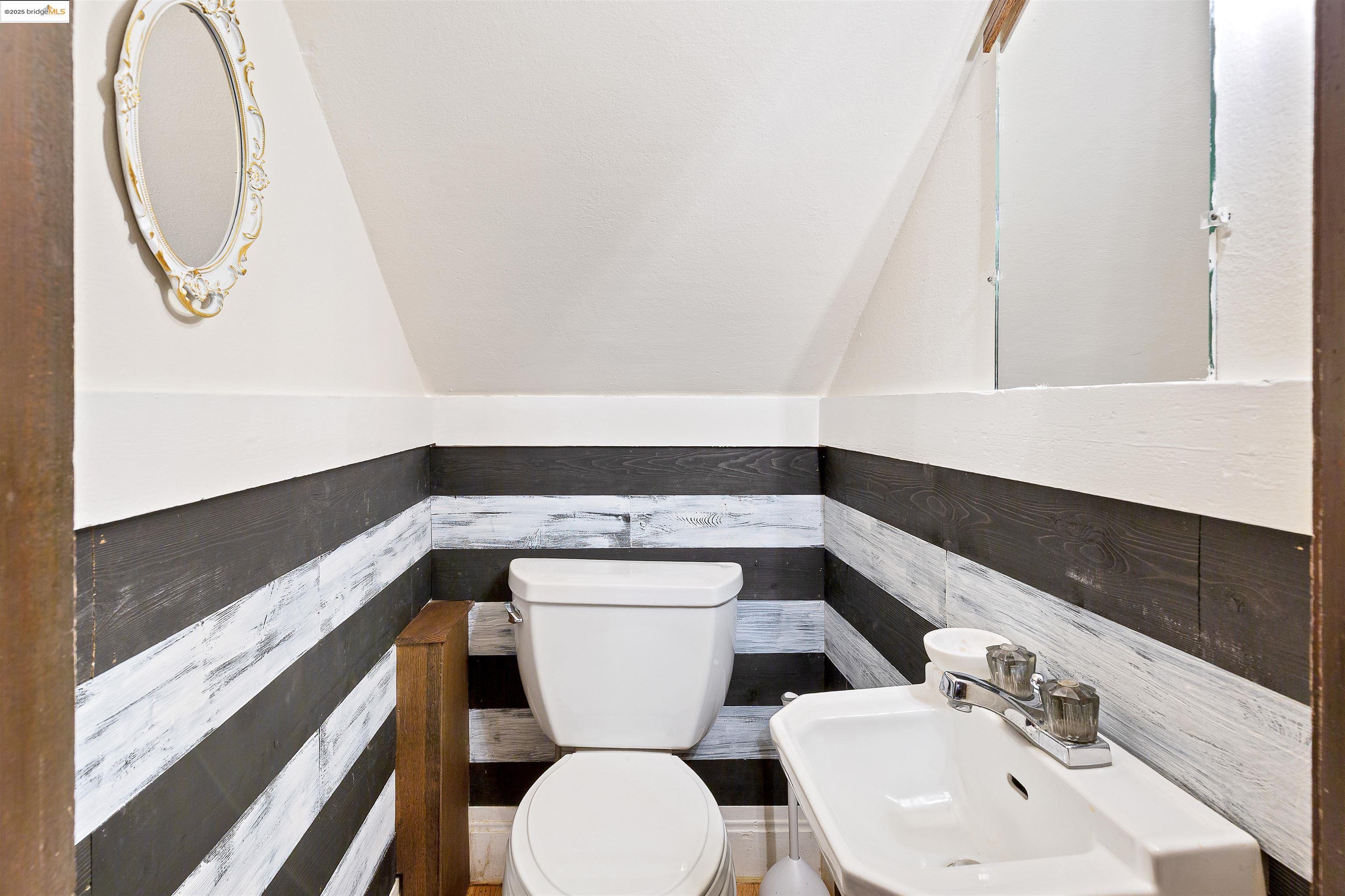 1512 Walnut Street Berkeley, CA 94709 - Photo 14 of 39 a bathroom with a toilet sink and mirror