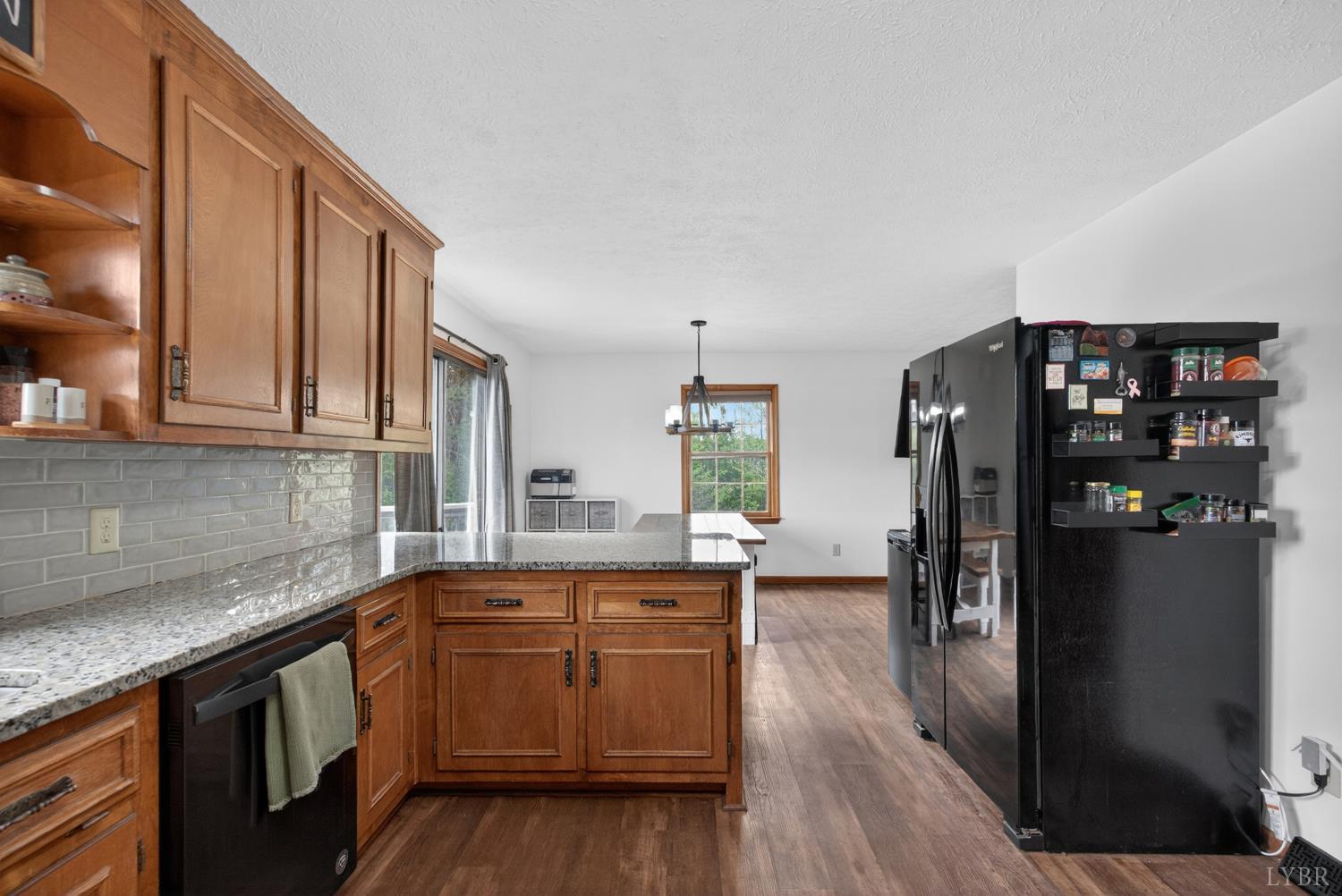 1002 Homeplace Road Rustburg, VA 24588 - Photo 18 of 48 a kitchen with stainless steel appliances granite countertop a refrigerator a sink dishwasher a stove and white countertops with wooden floor