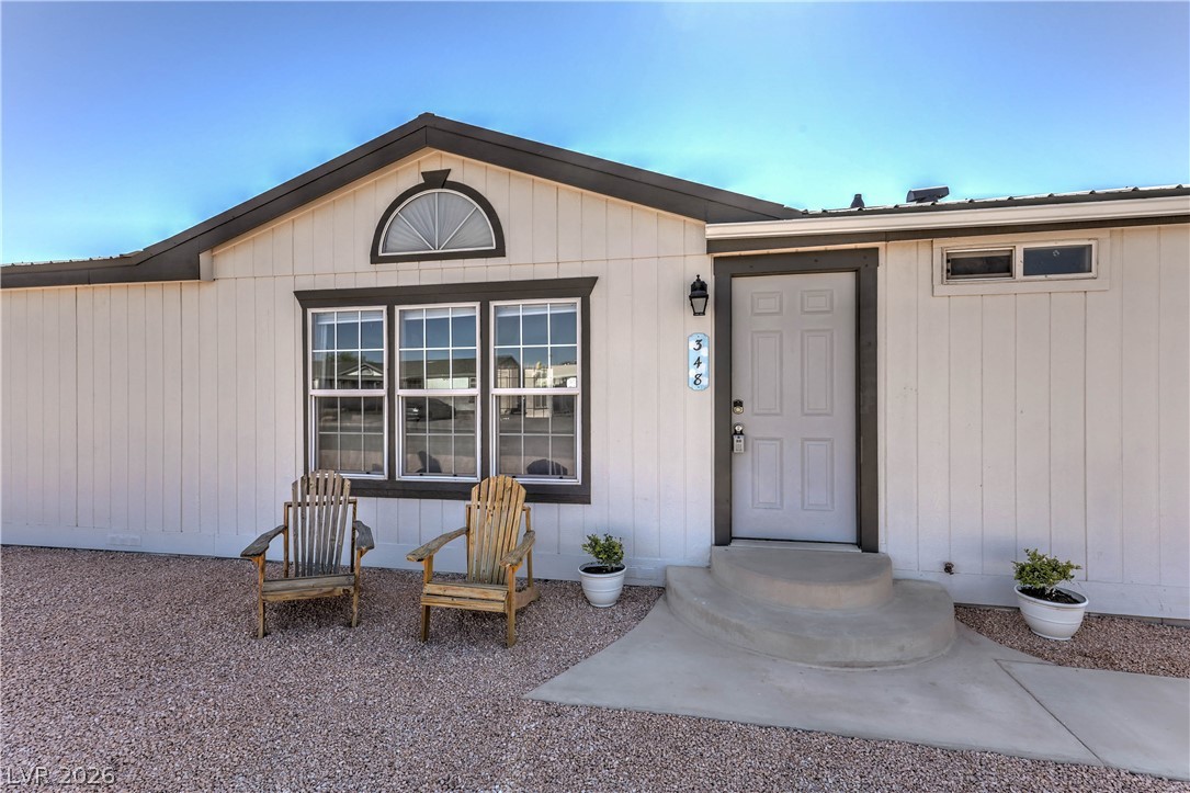 348 Tres Palomas Street Overton, NV 89040 - Photo 1 of 41 An inviting entry with simple landscaping and charming Adirondack chairs welcomes guests to this home.