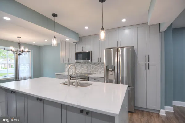 a kitchen with stainless steel appliances a refrigerator and a sink