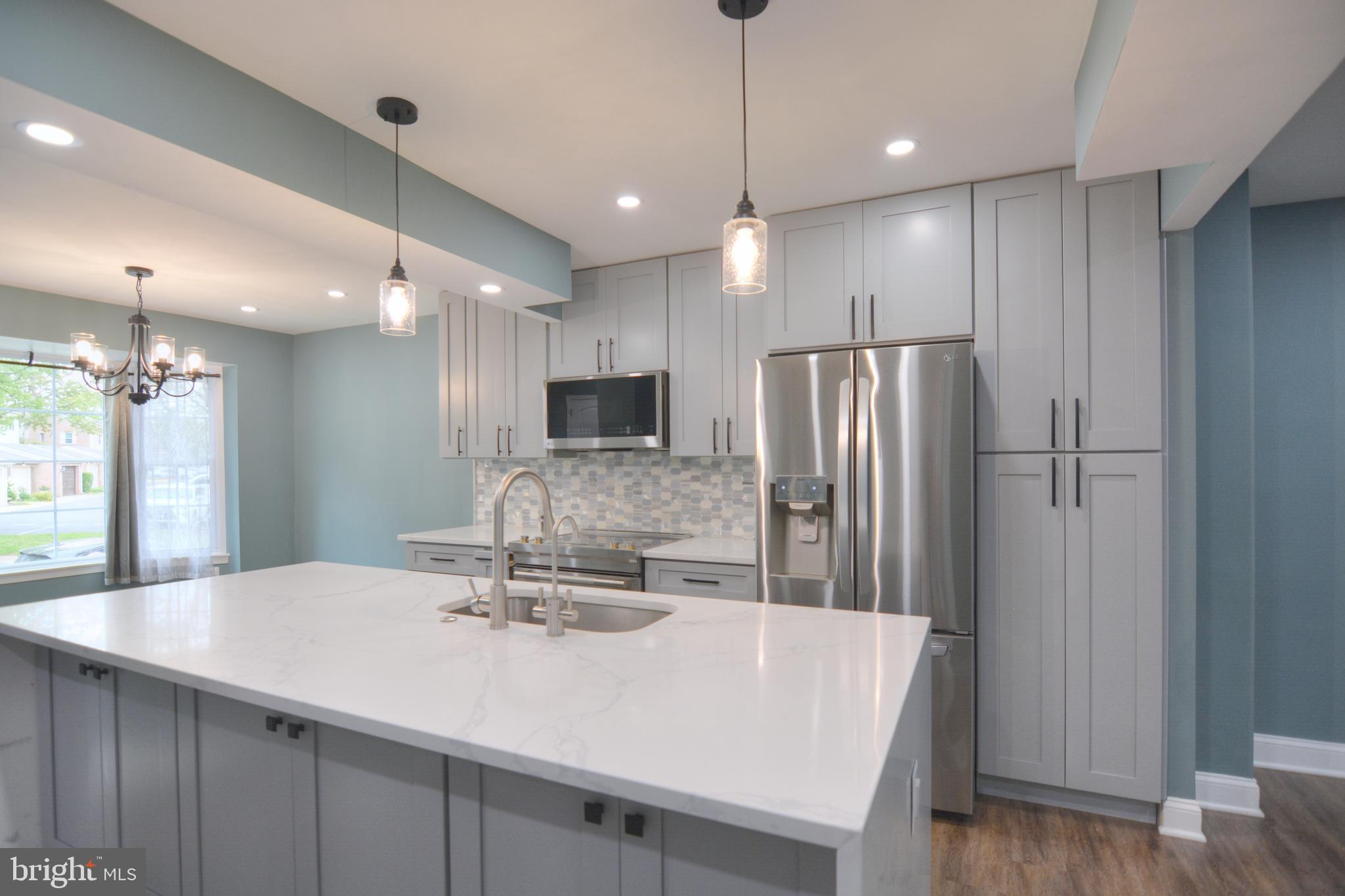 3822 Gawayne Terrace, Unit 32382 Silver Spring, MD 20906 - Photo 13 of 32 a kitchen with stainless steel appliances a refrigerator and a sink