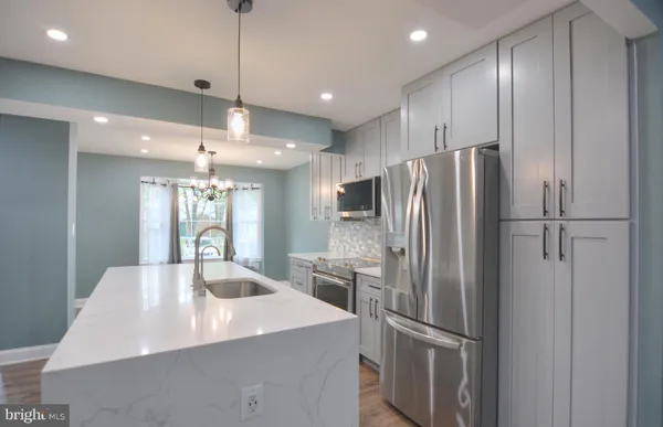 a kitchen with stainless steel appliances a refrigerator and a sink