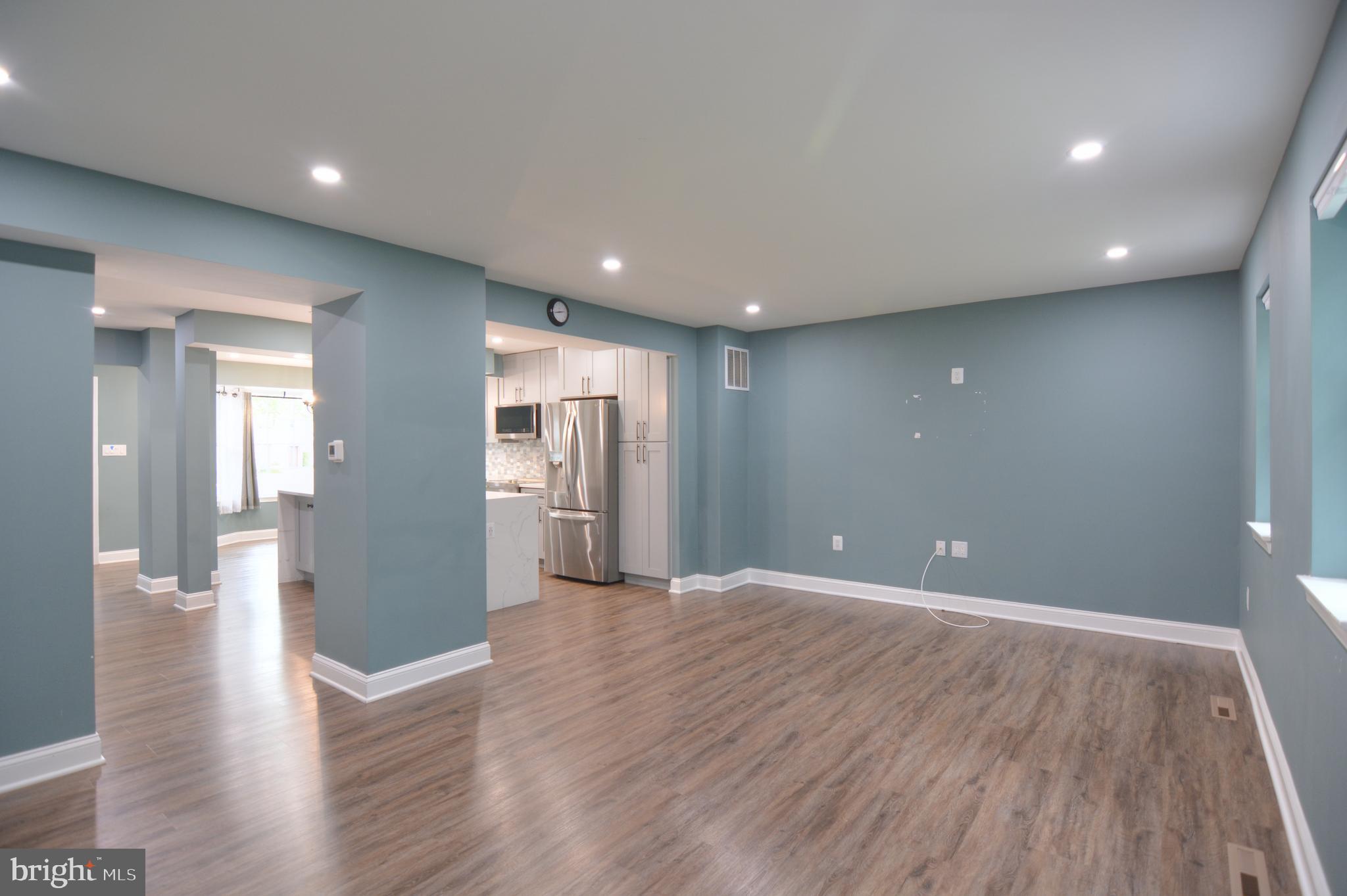 3822 Gawayne Terrace, Unit 32382 Silver Spring, MD 20906 - Photo 19 of 32 a view of a big room with wooden floor and windows