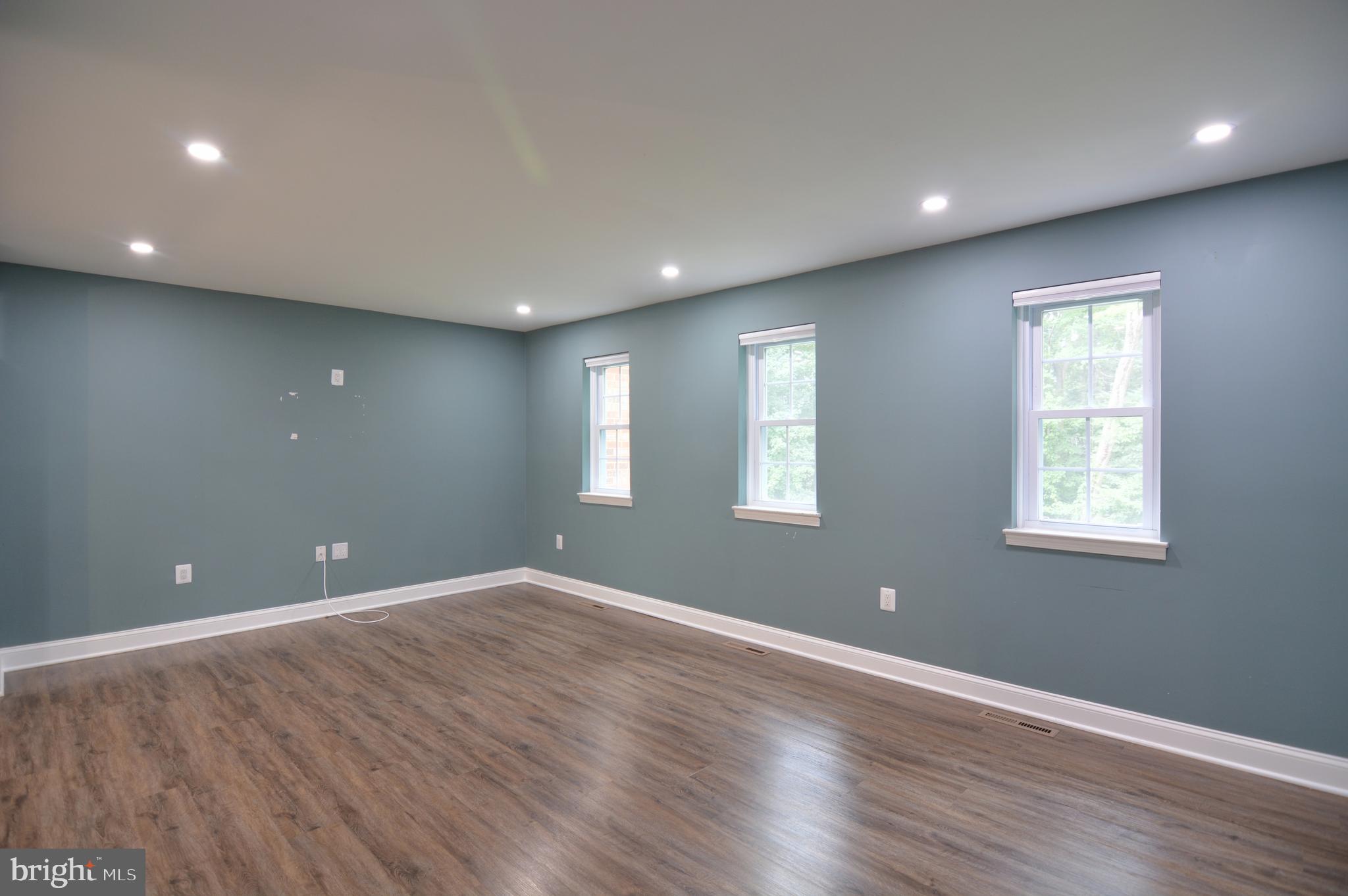 3822 Gawayne Terrace, Unit 32382 Silver Spring, MD 20906 - Photo 20 of 32 an empty room with wooden floor and windows