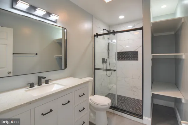 a bathroom with a sink toilet and shower