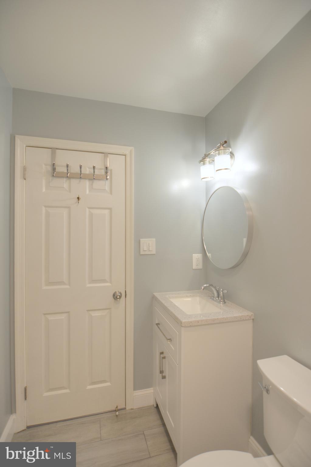 3822 Gawayne Terrace, Unit 32382 Silver Spring, MD 20906 - Photo 32 of 32 a bathroom with a toilet sink and mirror