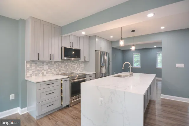 a kitchen with a stove a sink and a refrigerator