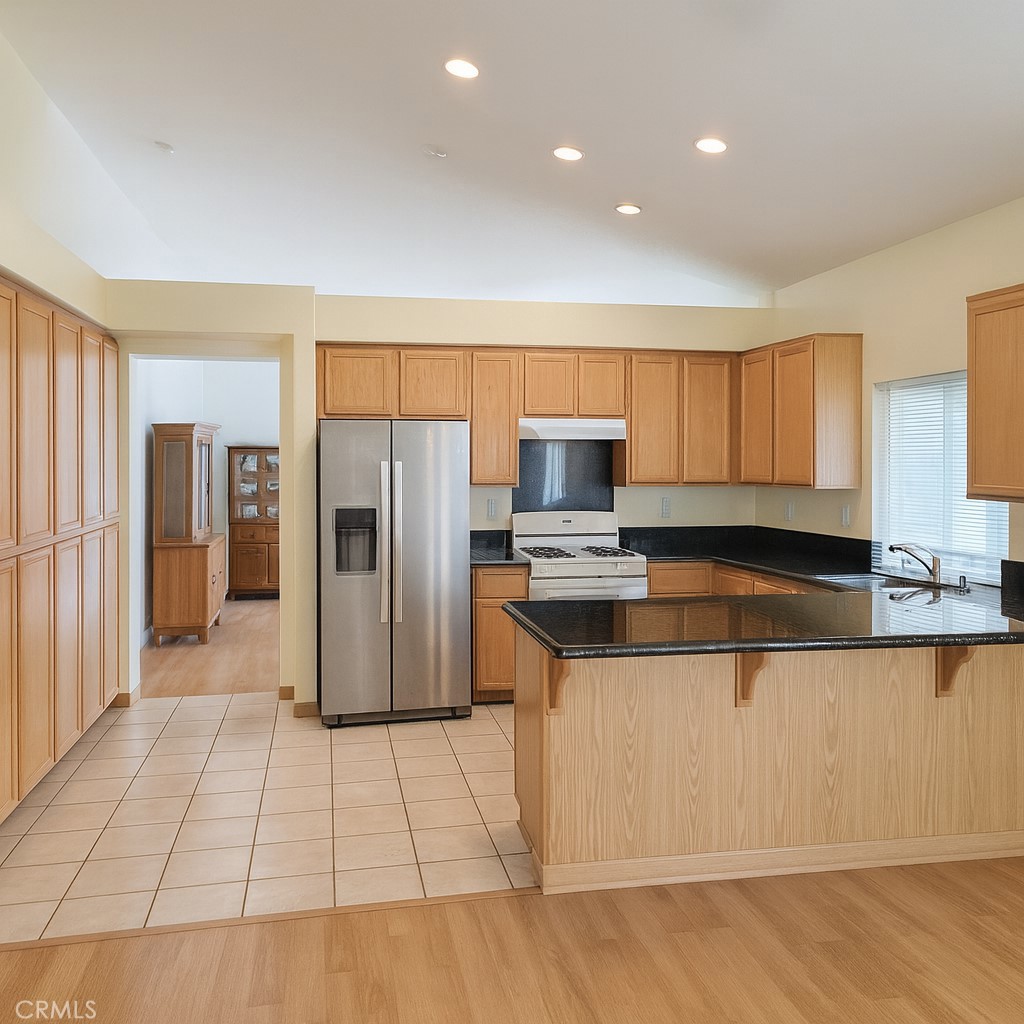 1457 Angelus Hill Road Hemet, CA 92545 - Photo 4 of 13 a kitchen with stainless steel appliances granite countertop a refrigerator and a stove top oven