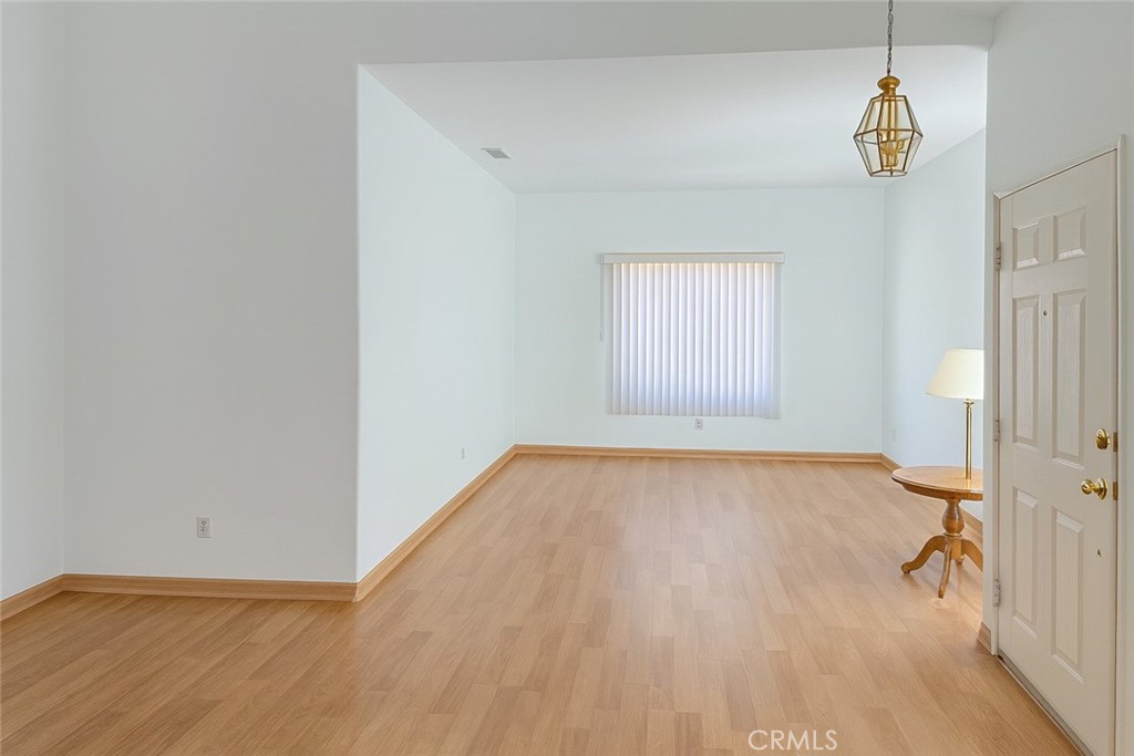 1457 Angelus Hill Road Hemet, CA 92545 - Photo 7 of 13 a view of empty room with a window and wooden floor
