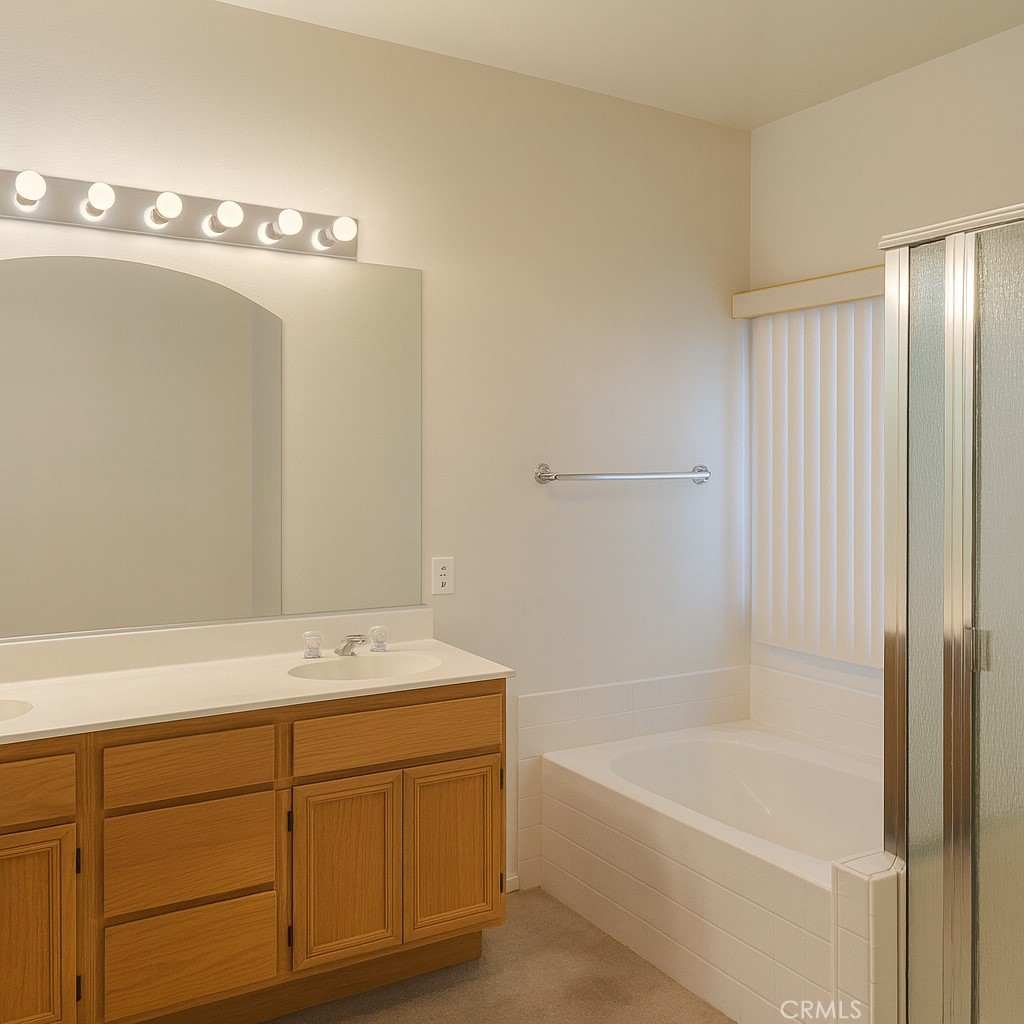 1457 Angelus Hill Road Hemet, CA 92545 - Photo 10 of 13 a bathroom with a sink a bath tub and a shower