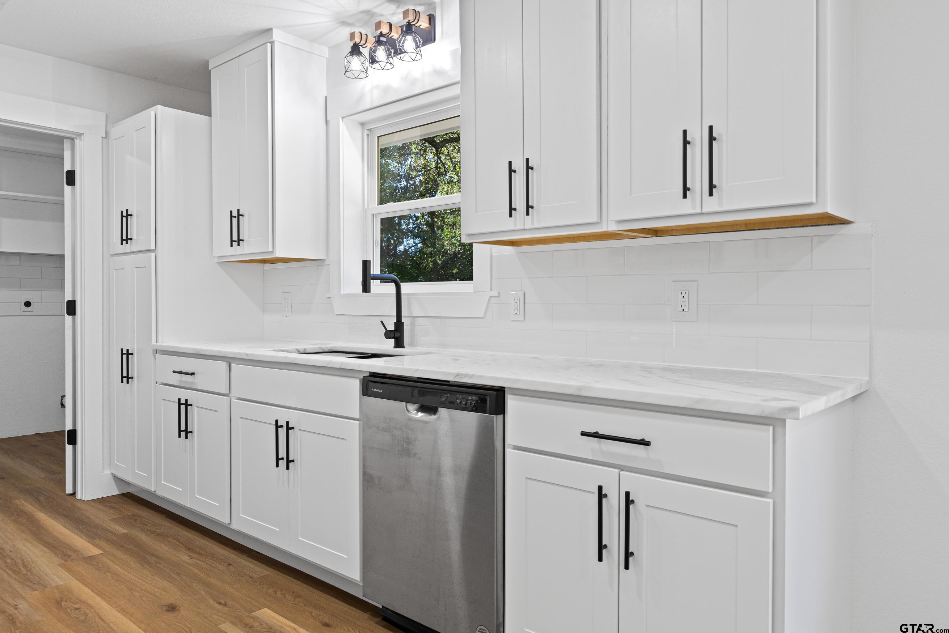 1907 Beth Drive Longview, TX 75605 - Photo 12 of 39 a kitchen with white cabinets and sink