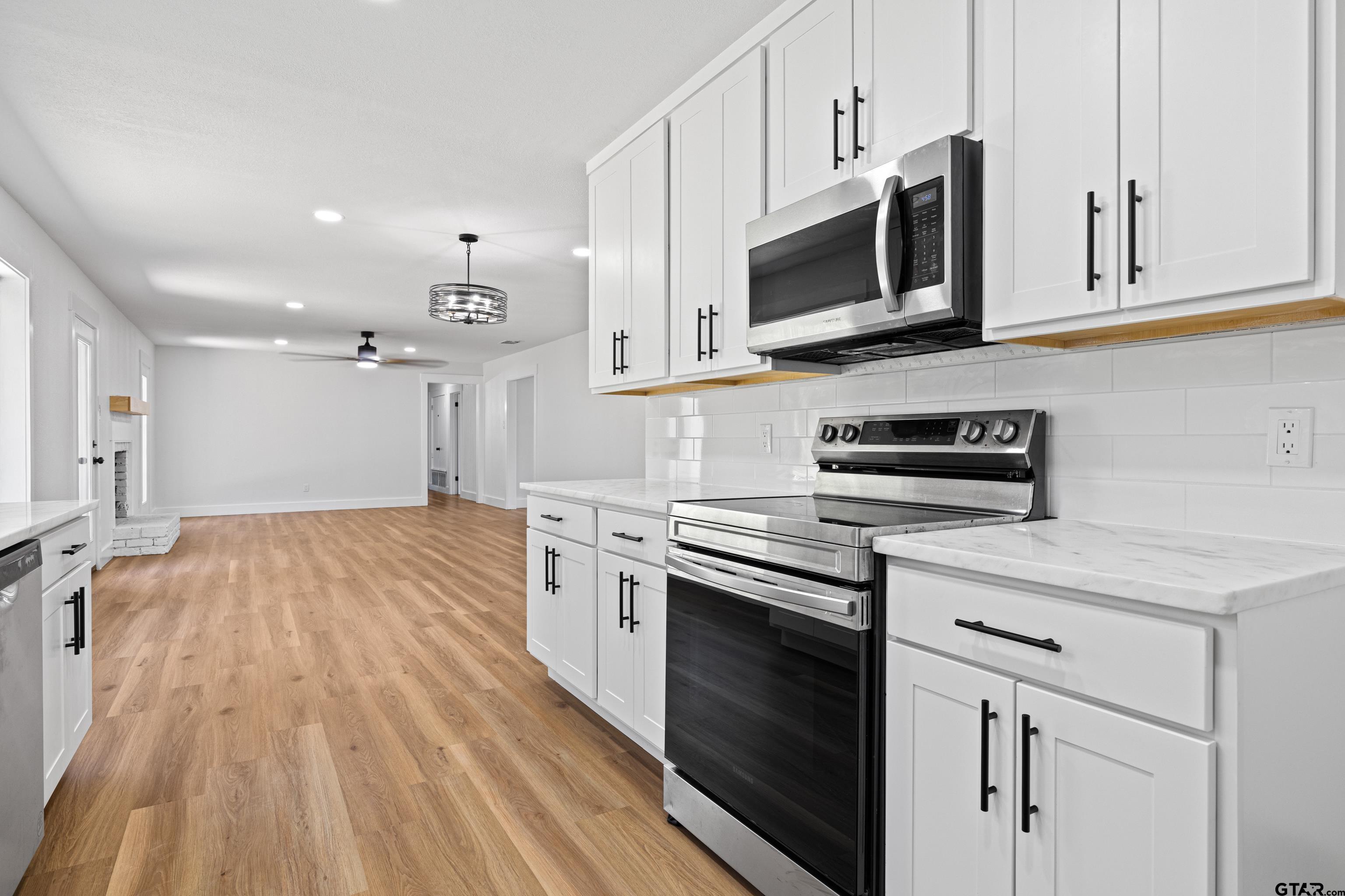 1907 Beth Drive Longview, TX 75605 - Photo 13 of 39 a kitchen with stainless steel appliances granite countertop a stove a sink and a microwave