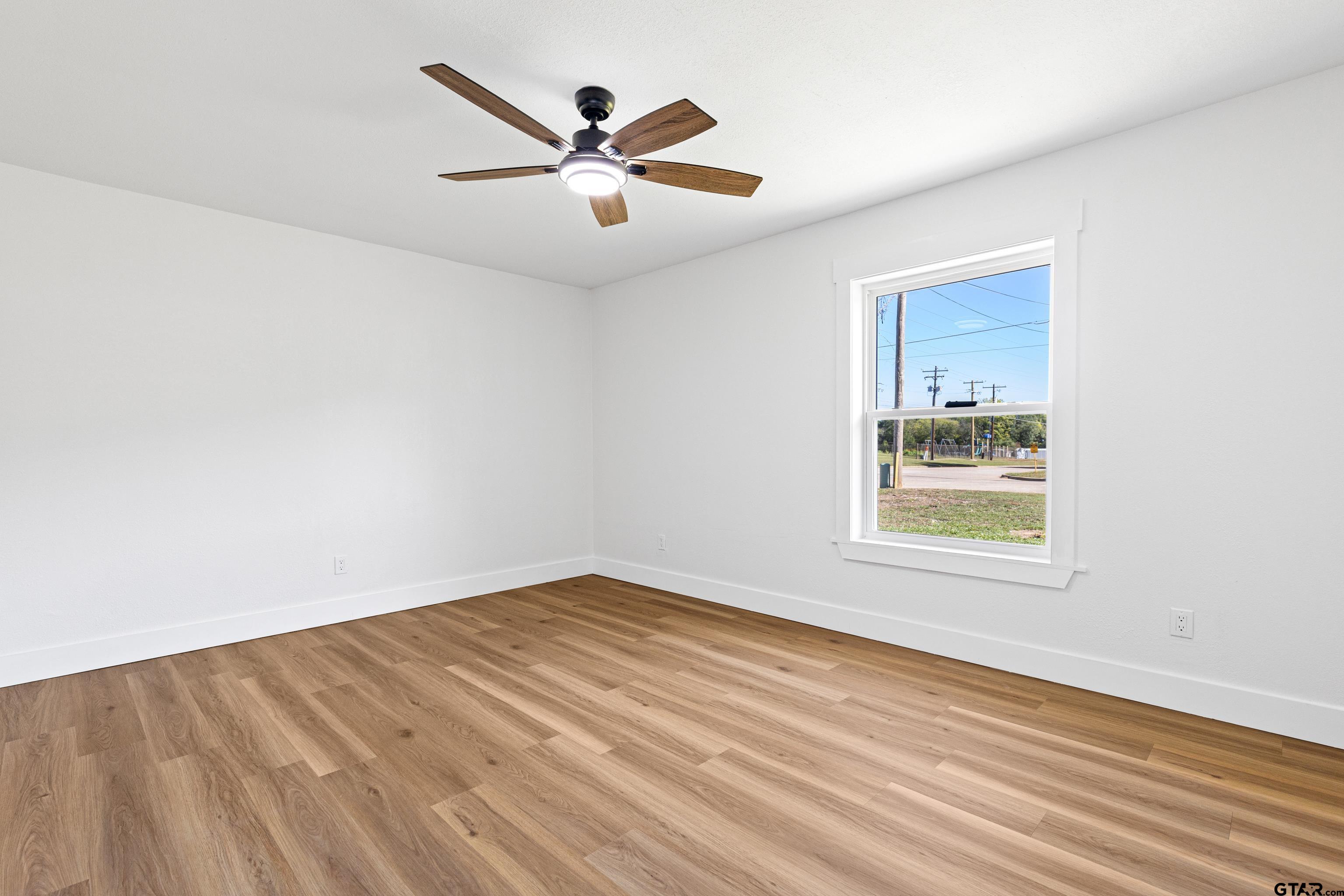 1907 Beth Drive Longview, TX 75605 - Photo 26 of 39 an empty room with wooden floor and windows