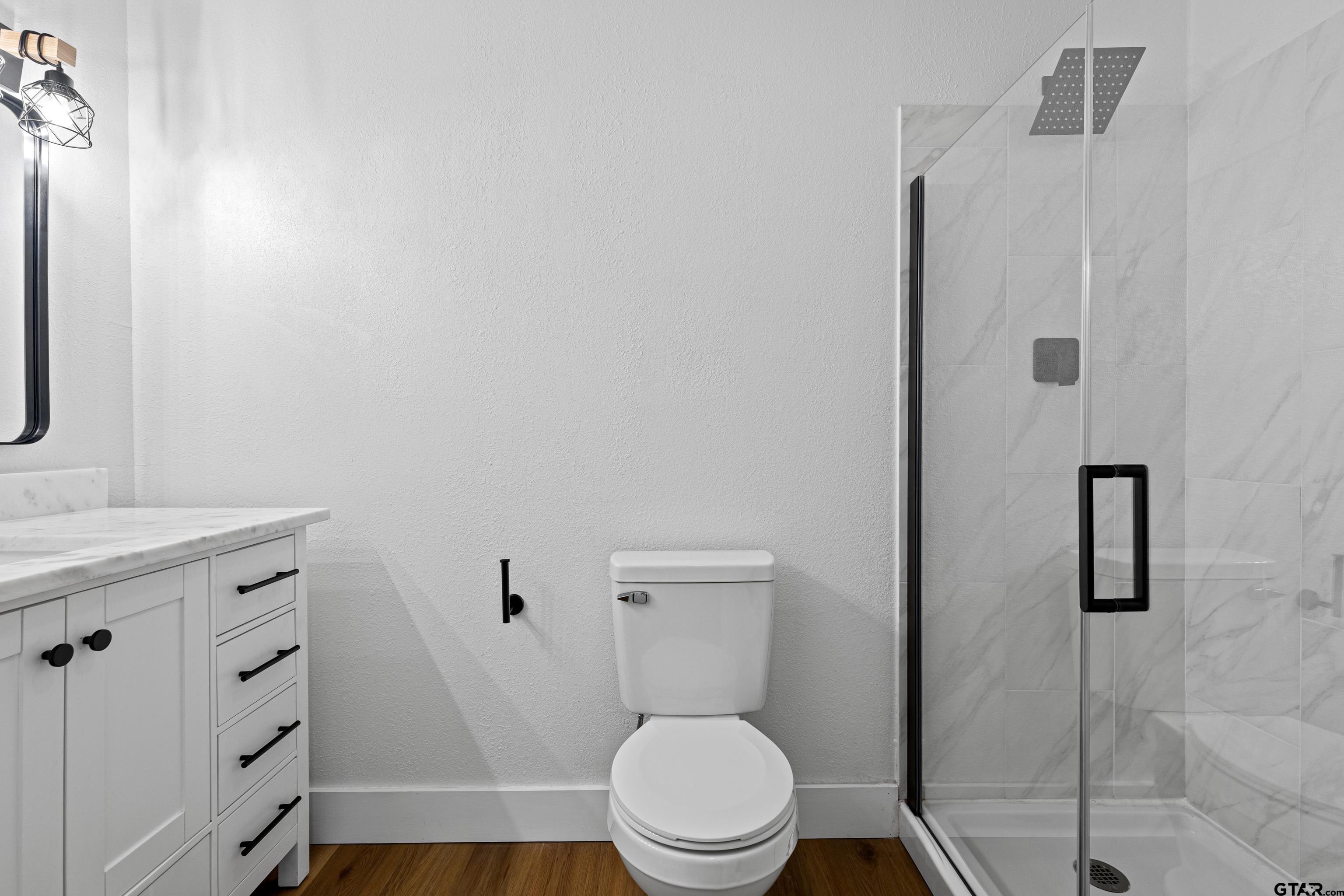 1907 Beth Drive Longview, TX 75605 - Photo 34 of 39 a white toilet sitting next to a bathroom sink