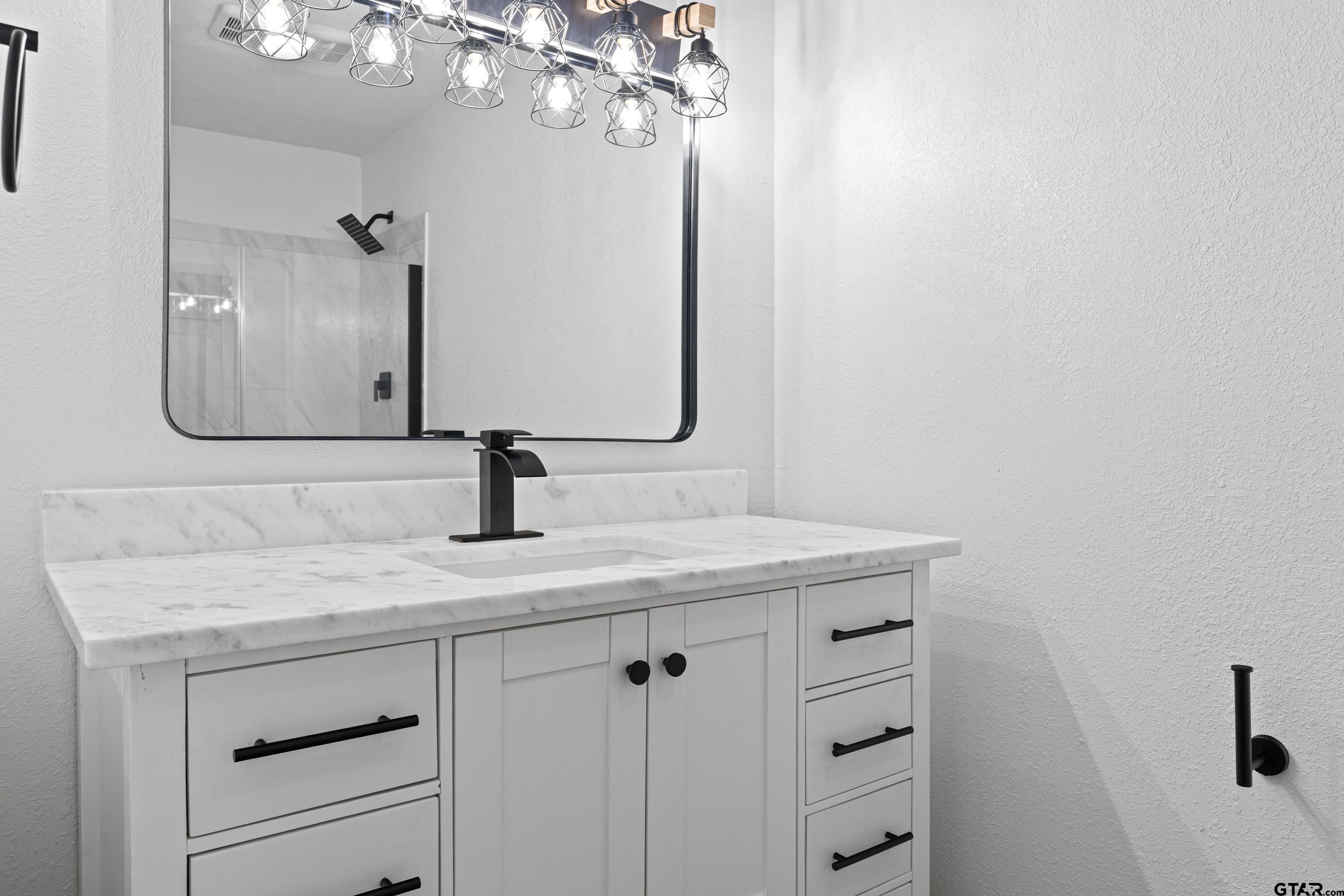1907 Beth Drive Longview, TX 75605 - Photo 35 of 39 a bathroom with a sink vanity and mirror