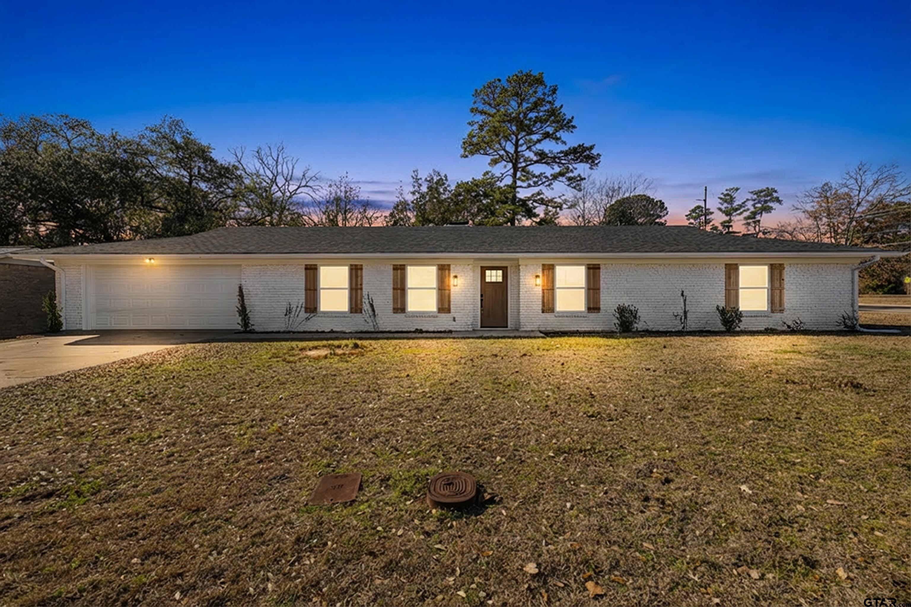 1907 Beth Drive Longview, TX 75605 - Photo 5 of 39 a front view of a house with a garden