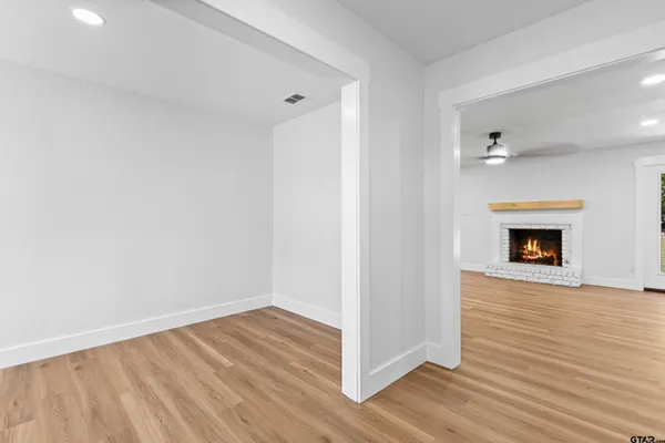 a kitchen with white cabinets and sink