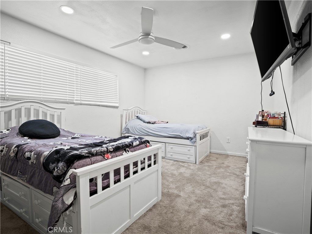 1455 North Alice Avenue Rialto, CA 92376 - Photo 18 of 23 a bedroom with furniture and a chandelier