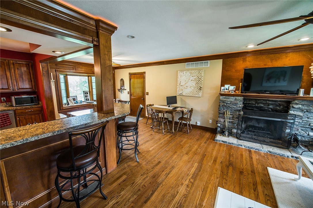 10744 Johnnycake Ridge Road Painesville, OH 44077 - Photo 8 of 31 Living room wood burning fireplace can be enjoyed from the kitchen and dining room.