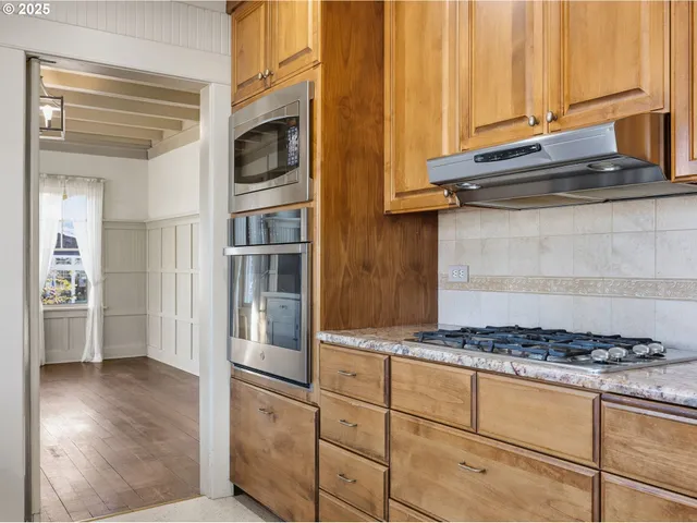 a kitchen with granite countertop stainless steel appliances and cabinets
