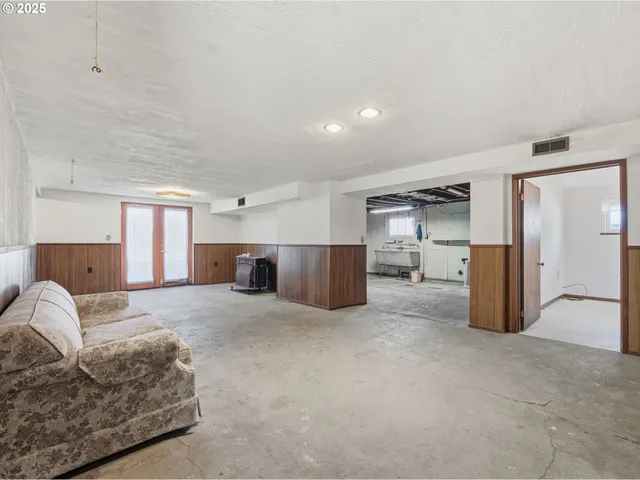 a large bedroom with a bed and cabinets