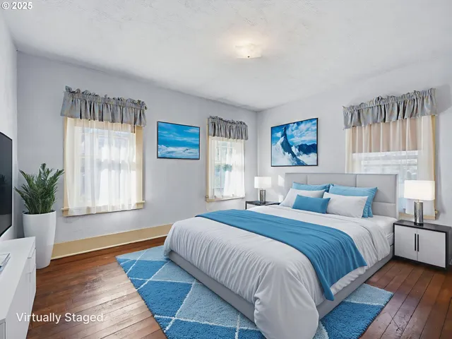 a bedroom with a large bed wooden floor and window