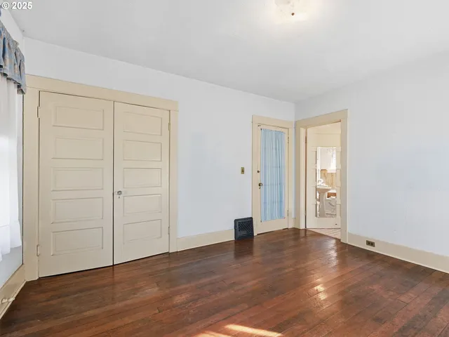 an empty room with wooden floor