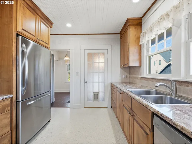 a kitchen with a granite countertop refrigerator and a sink