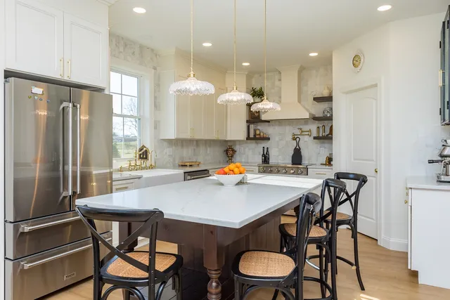 a bathroom with a sink mirror and a toilet