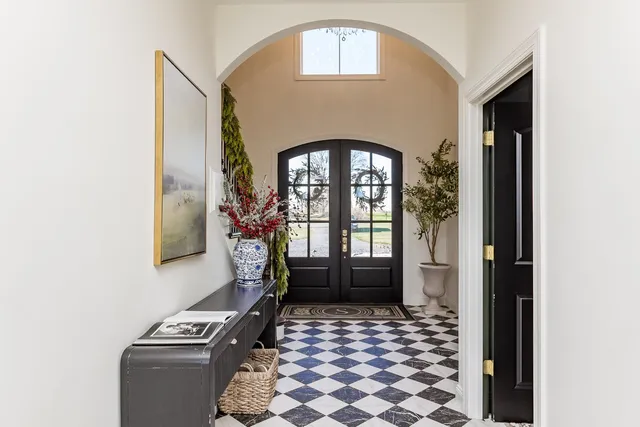 a dining room with furniture a chandelier and wooden floor