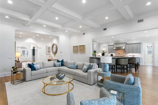 a living room with furniture and a dining table with kitchen view