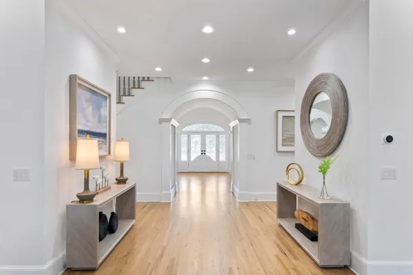 a view of a living room a dining room wooden floor and a fireplace