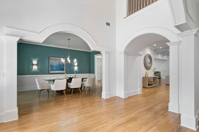 a view of a living room and dining room with wooden floor