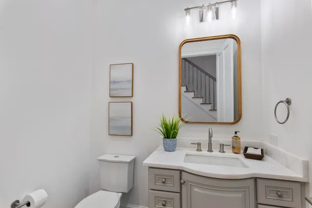 a bathroom with a toilet sink and mirror