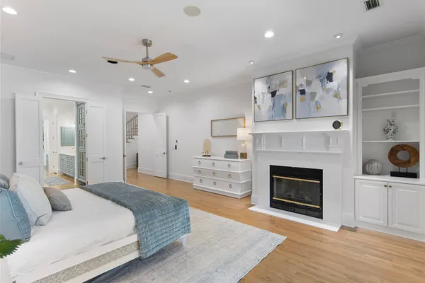 a spacious bedroom with a large bed and a fireplace