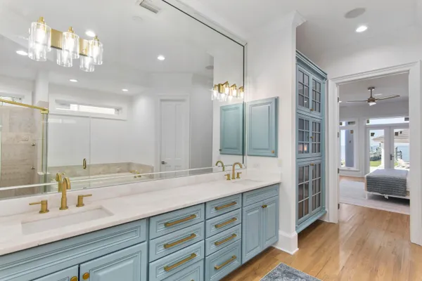 a spacious bathroom with double vanity and a large mirror