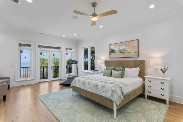 a bedroom with a large bed and a chandelier